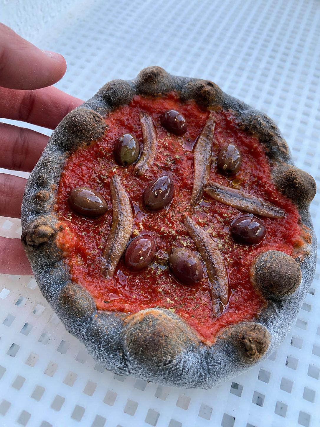 Charcoal dough marinara special with anchovies and olives